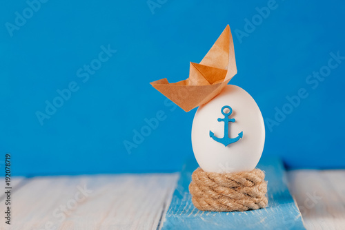 Photography Easter egg with marine decor on a wooden background