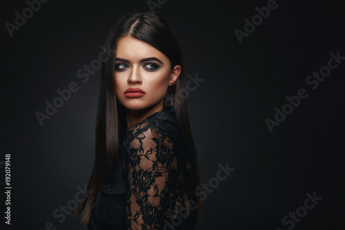 Beauty portrait of a young black-haired woman in the studio