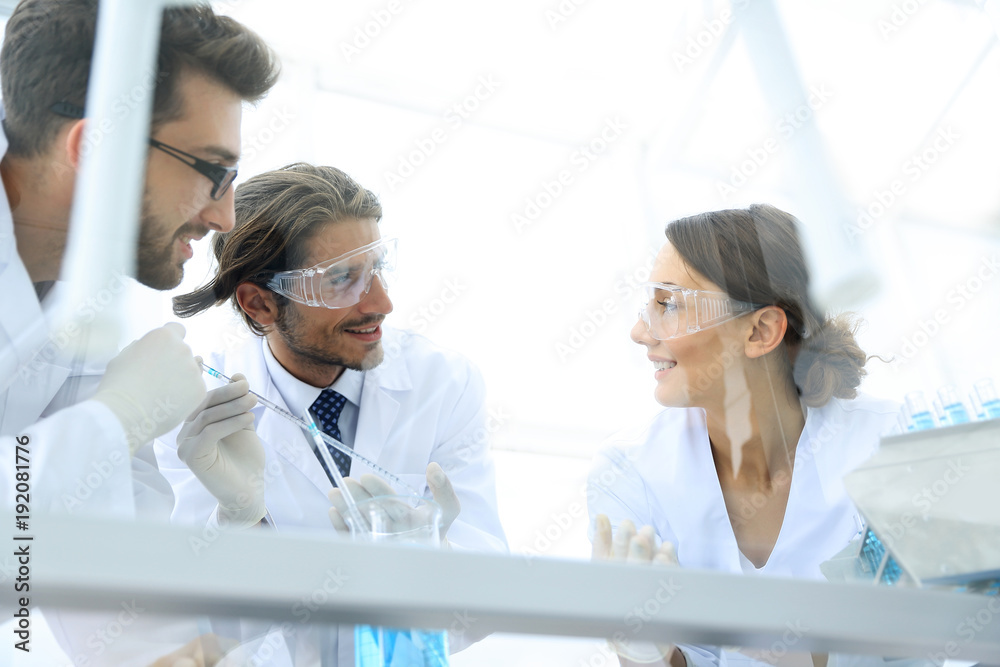 Fototapeta premium Group of scientists working on an experiment at the laboratory