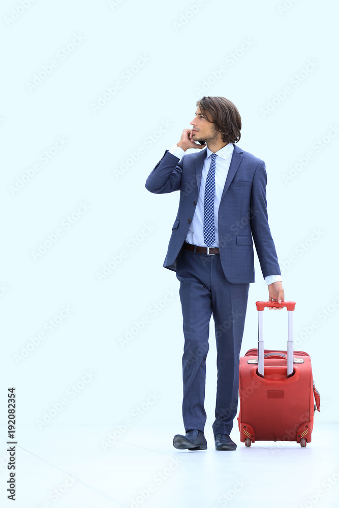 successful businessman with Luggage talking on the phone. successful businessman with Luggage talking on the phone.