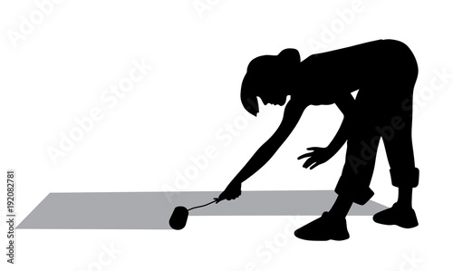 Woman painting floor with paint roller