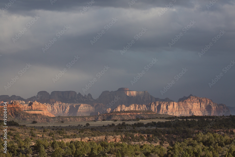 The mountains of Zion National Park with dappled light and shade on a stormy winter day