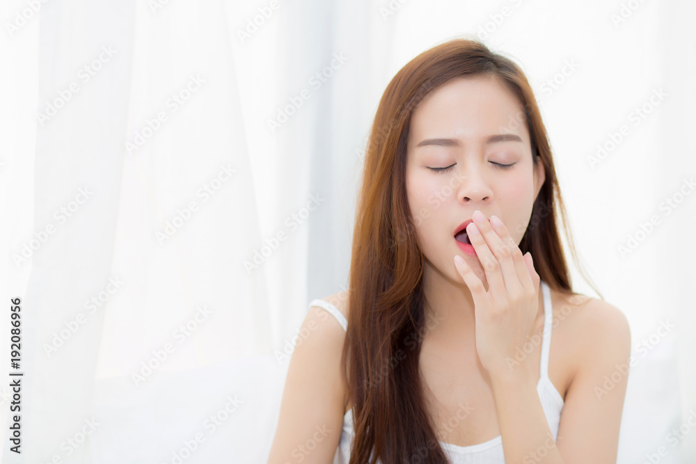 Beautiful young asian woman yawn sitting with sleep on bed at bedroom, girl wake up after resting and leisure with wellness, lifestyle concept. Beautiful young asian woman yawn sitting with sleep on bed at bedroom, girl wake up after resting and leisure with wellness, lifestyle concept.