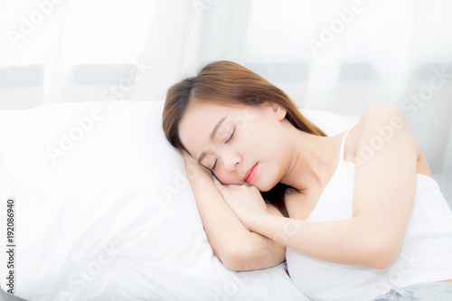 Beautiful asian young woman sleeping lying in bed with head on pillow comfortable and happy. girl with relax for health concept.