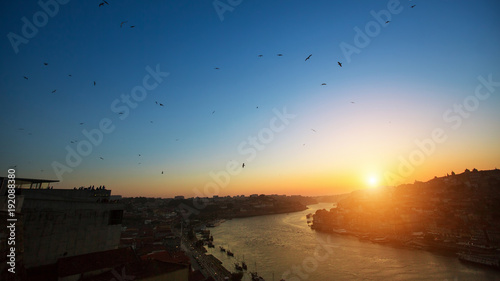 View of Douro river from Dom Luis I bridge during amazing sunset, Porto, Portugal.