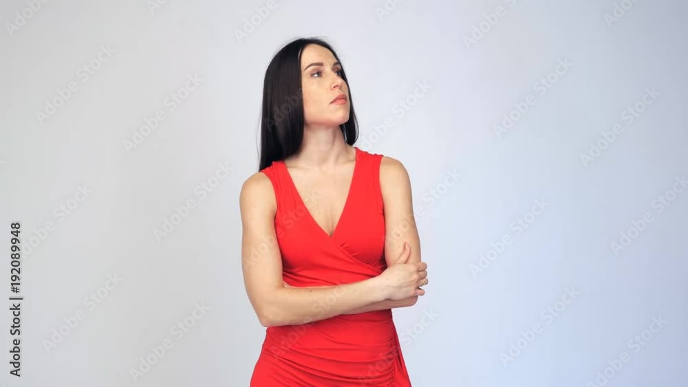 Close-up of female in red dress waiting for someone isolated Close-up of female in red dress waiting for someone isolated
