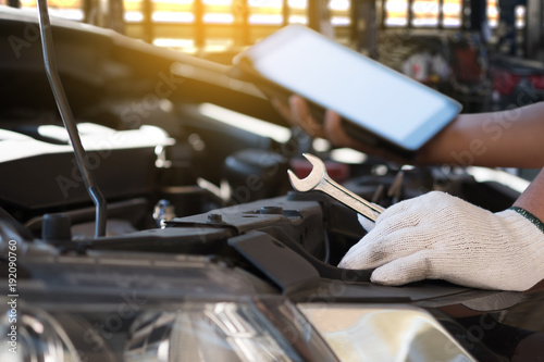 Mechanic repairing a car in garage Auto repair car engine, close u