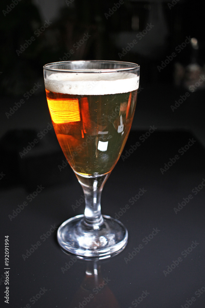 Beer on glass on black reflective studio background. Isolated black shiny mirror mirrored background for every concept.. Beer on glass on black reflective studio background. Isolated black shiny mirror mirrored background for every concept..