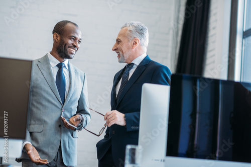 portrait of smiling multiracial businessmen in office photo