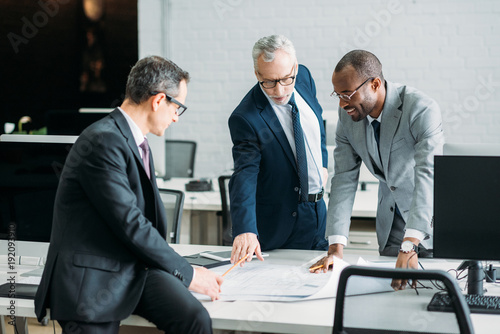 multiethnic businessmen discussing new business strategy on meeting in office