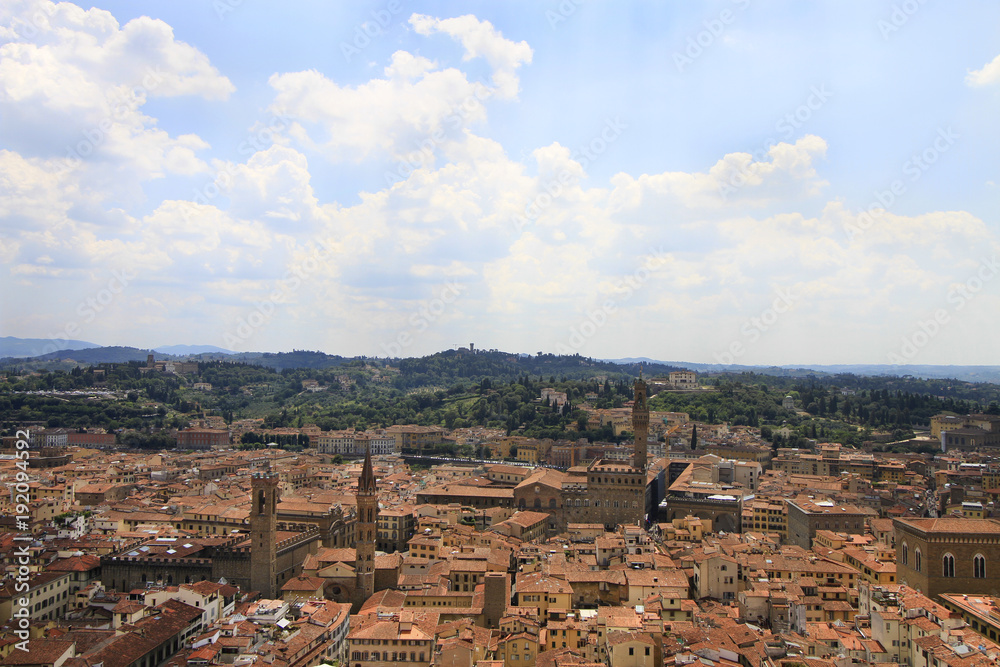 City panorama, aerila view, Florence, Tuscany, Italy; roofs, buildings, towers and hilly suburbs in the background.