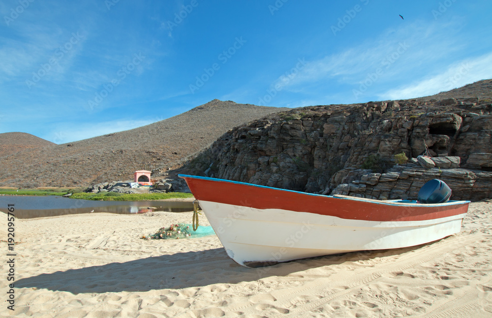Small fishing boat / ponga at Punta Lobos beach on the coast of Baja California Mexico BCS
