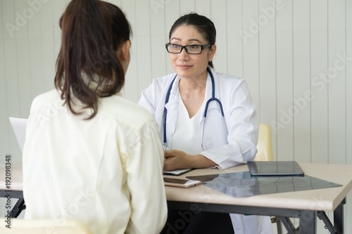 Female doctor meeting with a patient in the office  she is giving a prescription to woman  healthcare and medicine concept.Doctor talking patient .