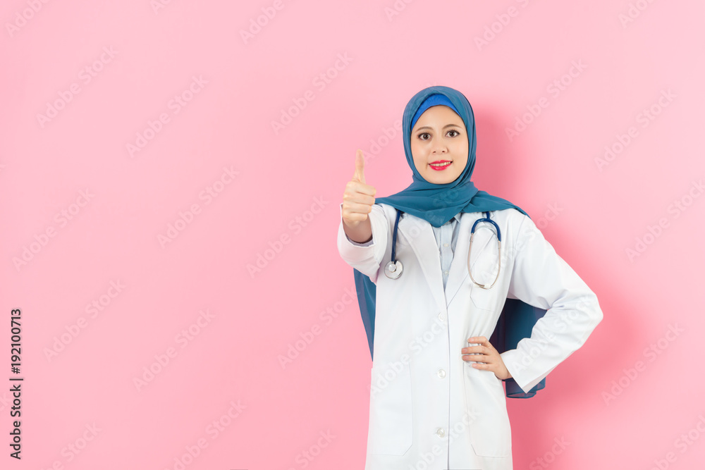 muslim woman doctor standing in pink background