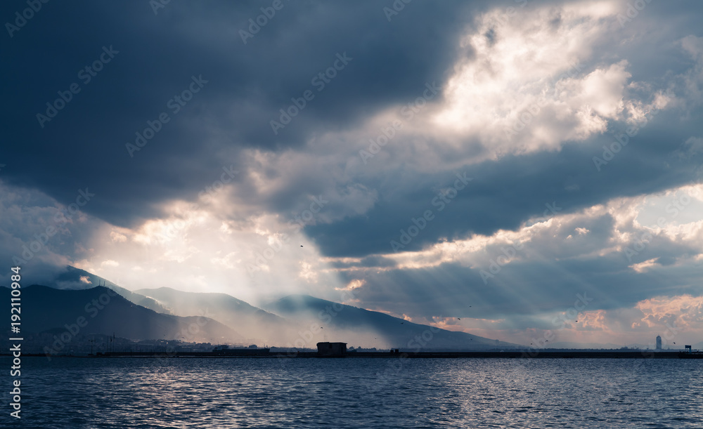 Dark stormy clouds with sunbeams, Izmir