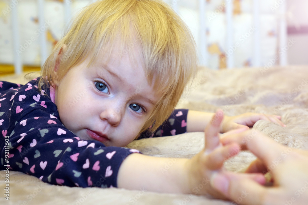 Fototapeta premium Beautiful child lying on the bed.