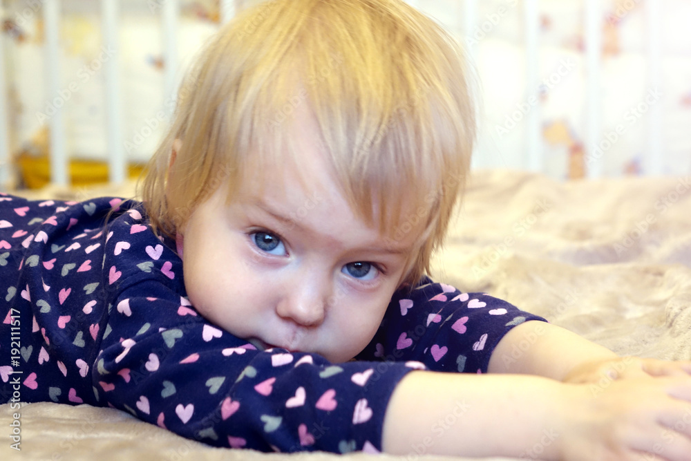 Beautiful child lying on the bed. Beautiful child lying on the bed.