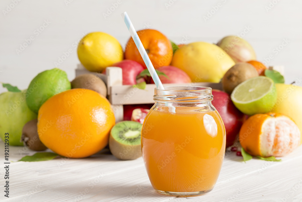 A glass of juice with a straw from different fruits A glass of juice with a straw from different fruits