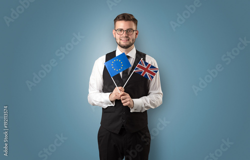 Handsome student standing with national flag