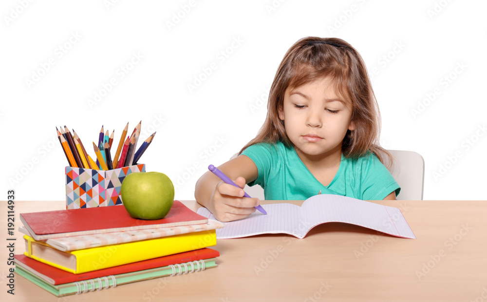 Cute little girl doing homework against white background Cute little girl doing homework against white background