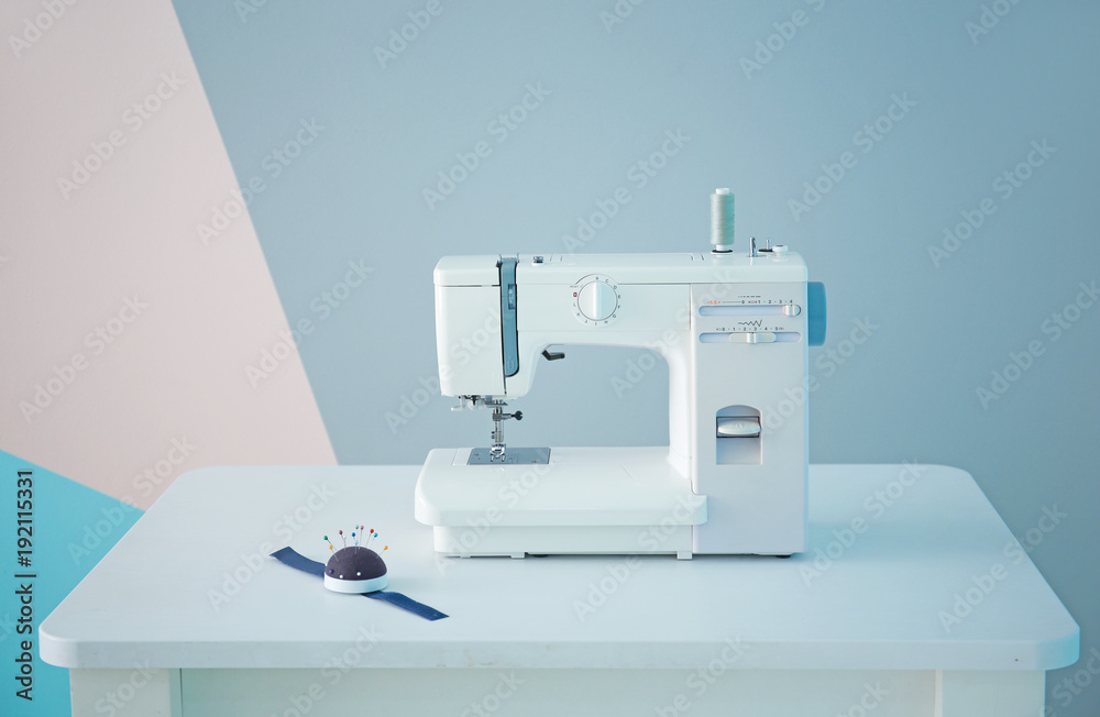 Sewing machine on table in tailor's workshop