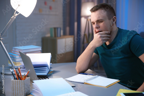 Tired student doing homewor...