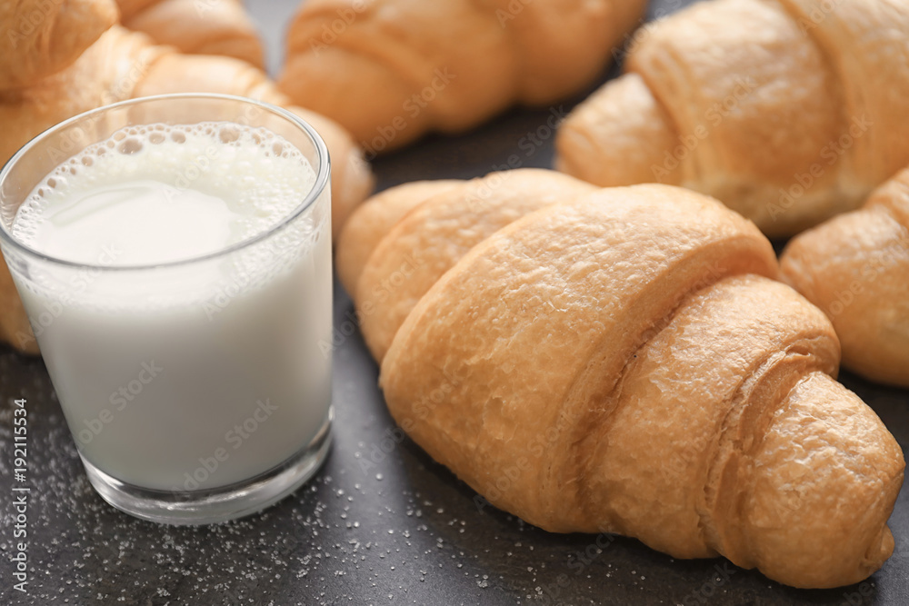 Tasty croissants and glass of milk on table Tasty croissants and glass of milk on table