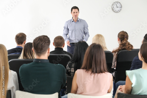 Group of people with business trainer at management seminar