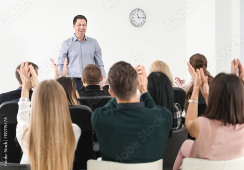 Group of people with business trainer at management seminar