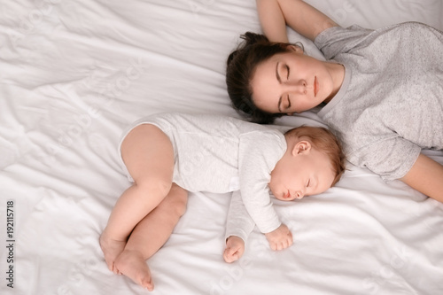 Mother with her baby sleepi...