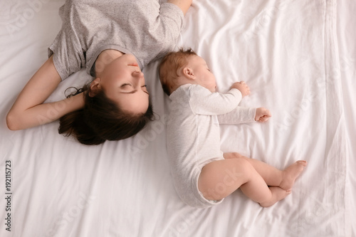 Mother with her baby sleepi...