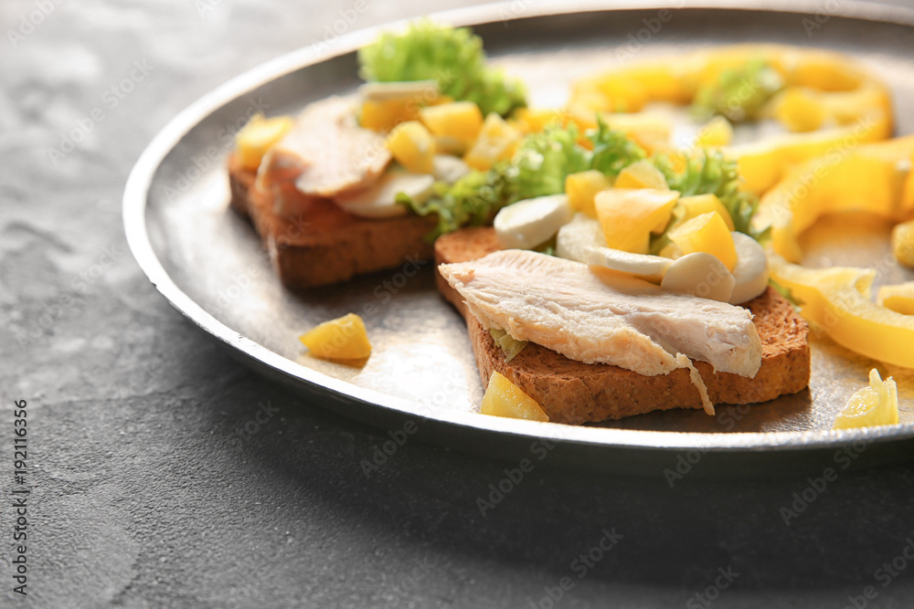 Plate with tasty chicken bruschettas on table Plate with tasty chicken bruschettas on table