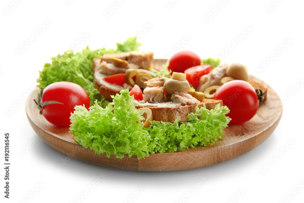 Wooden plate with tasty chicken bruschettas on white background Wooden plate with tasty chicken bruschettas on white background