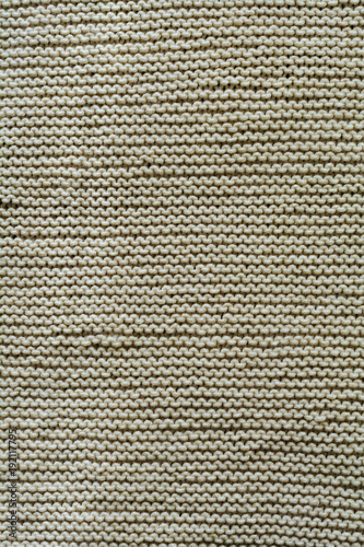Beige knitted wool texture background pattern vertical background. Selective focus. Top view. Copy space.
