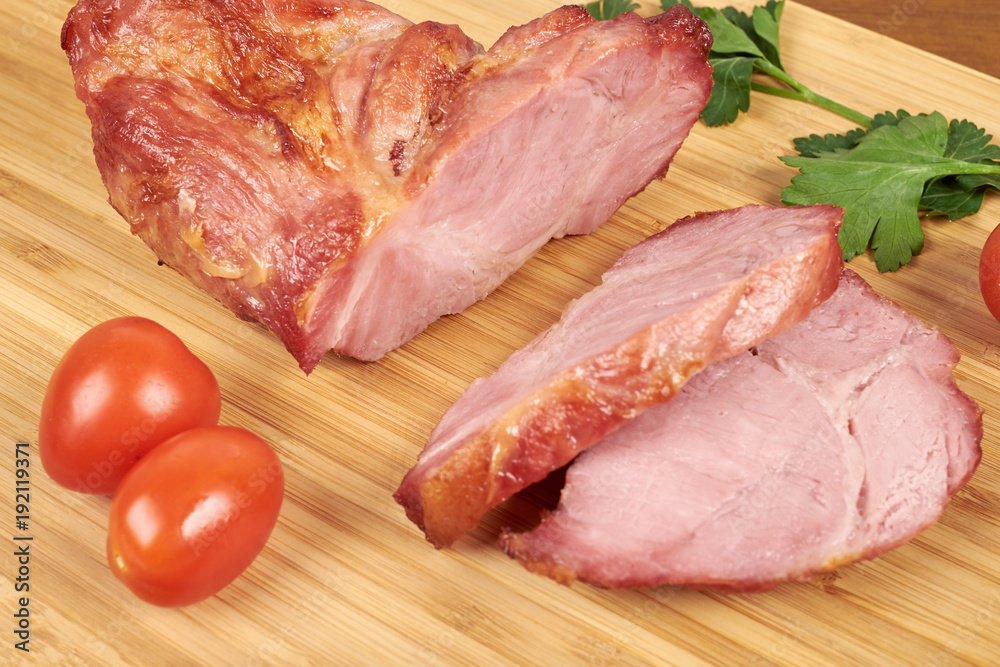 Cooked sliced pork ham steak on wooden cutting board. Cooked sliced pork ham steak on wooden cutting board.