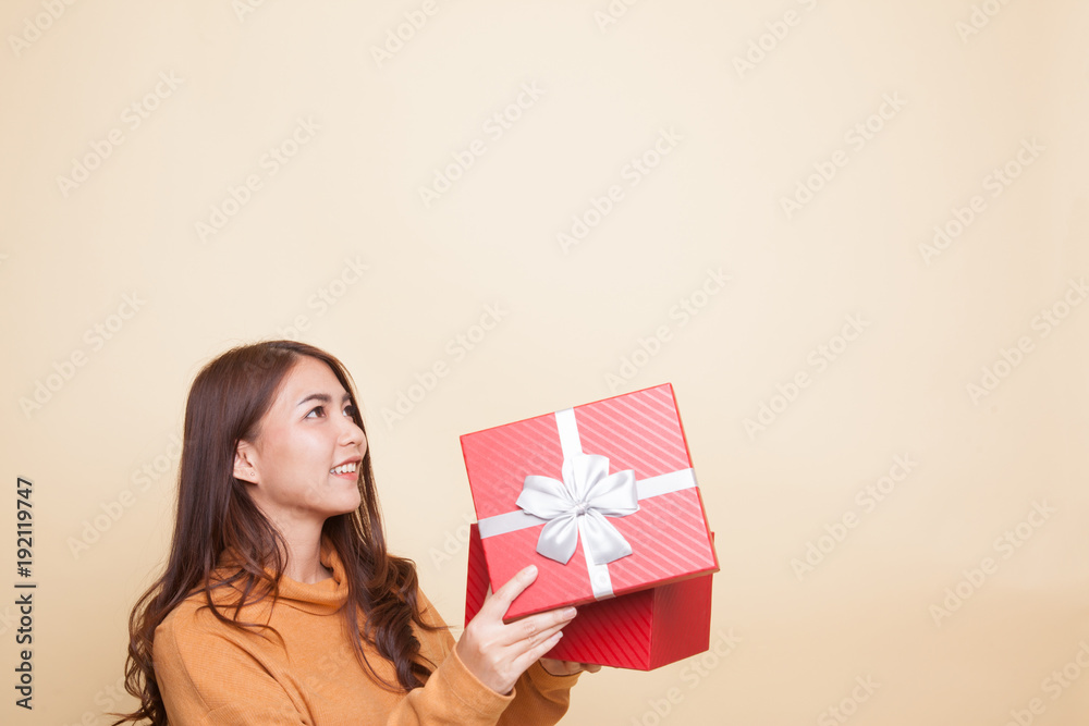 Young Asian woman open a gift box. Young Asian woman open a gift box.