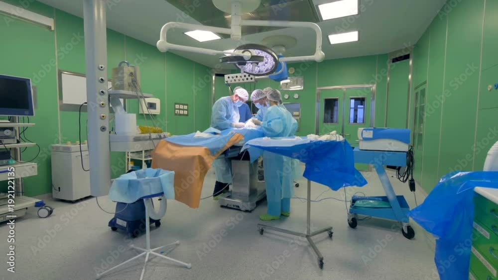 General view of an operating room with doctors holding an operation in it. 4K. General view of an operating room with doctors holding an operation in it. 4K.
