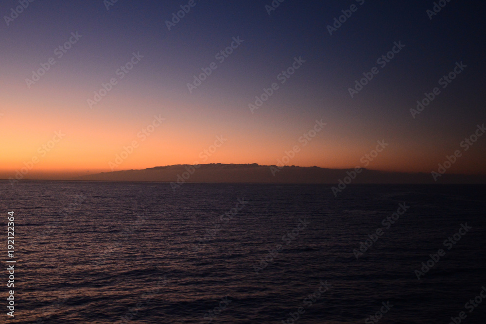 Travelling from Tenerife to La Gomera in the twilight with a ferry, view to the island La Gomera