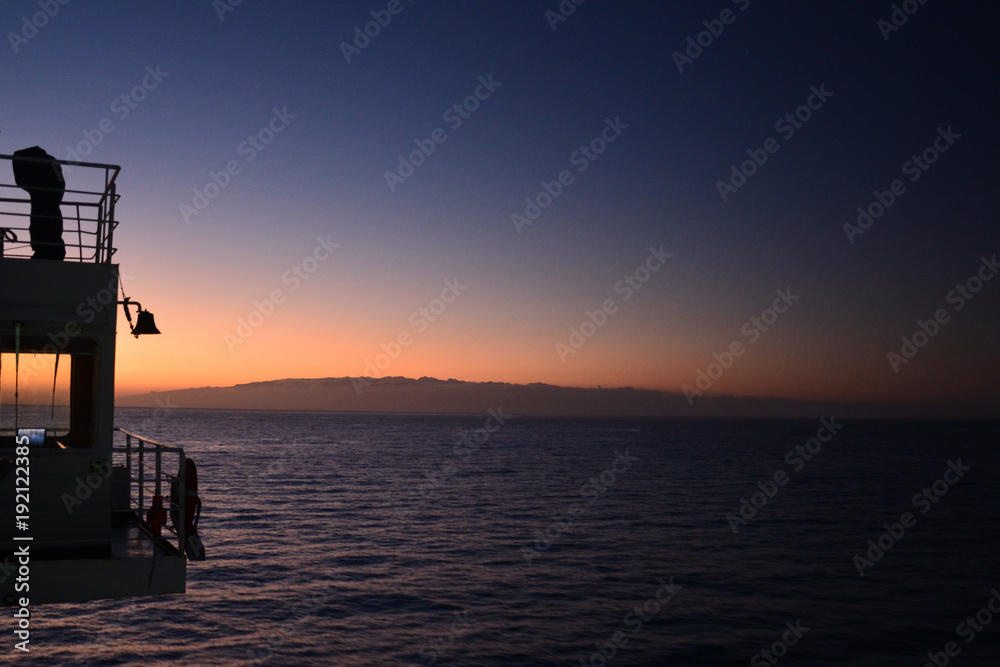 Travelling from Tenerife to La Gomera in the twilight with a ferry, view to the island La Gomera Travelling from Tenerife to La Gomera in the twilight with a ferry, view to the island La Gomera