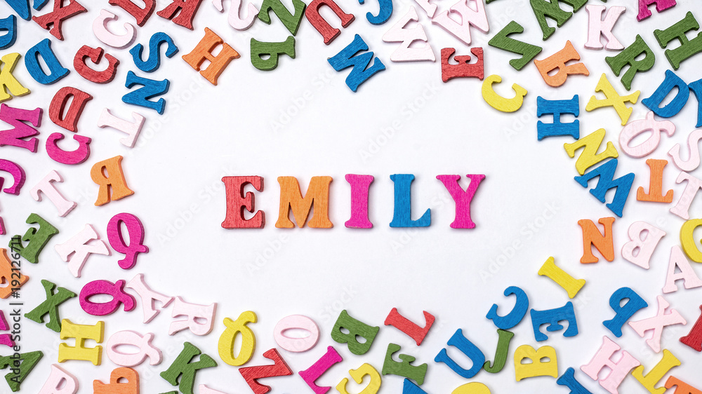 Baby name EMILY composed of wooden letters on floor. Choosing name concept