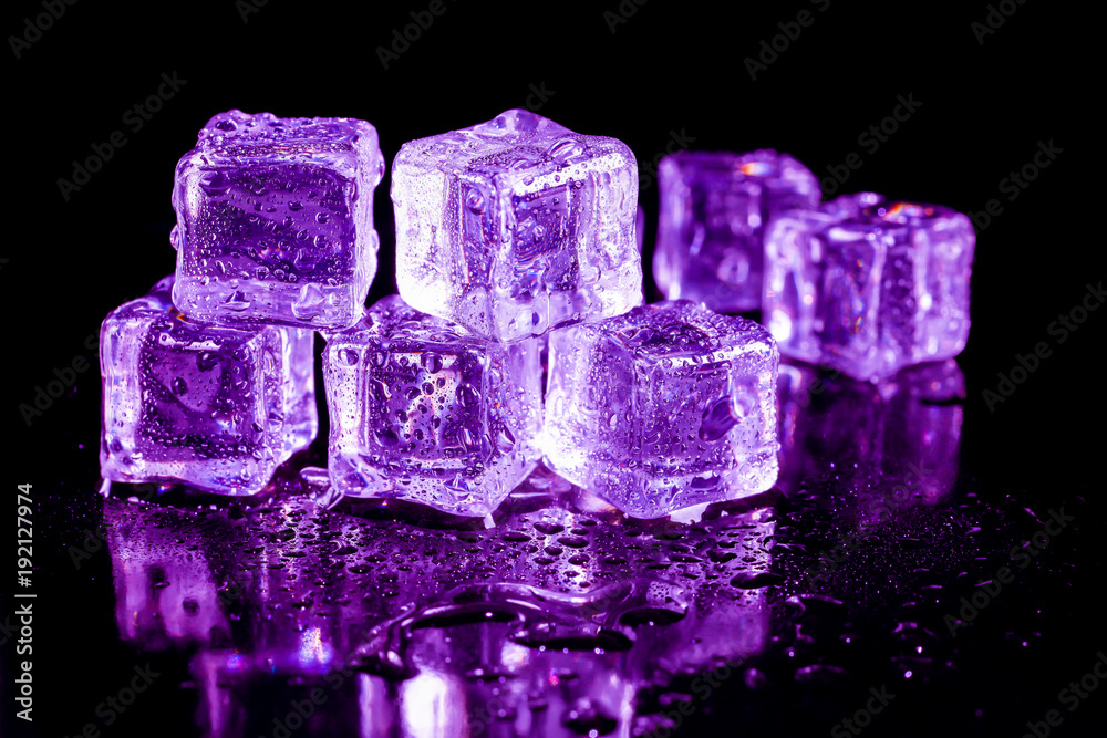 Purple ice cubes on a black table. Purple ice cubes on a black table.