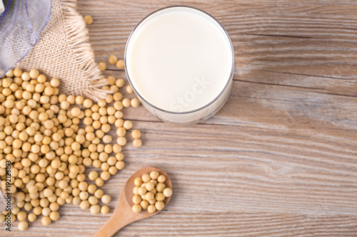 Top view of soybeans and soy milk in a glass on table