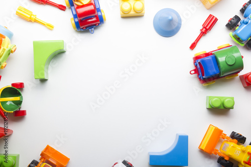 Kids educational developing toys frame on white background. Top view. Flat lay. Copy space for text photo