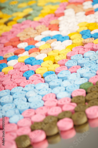 Detail of pills of MDMA (Extasy) distributed by drug dealer seized by legal authority