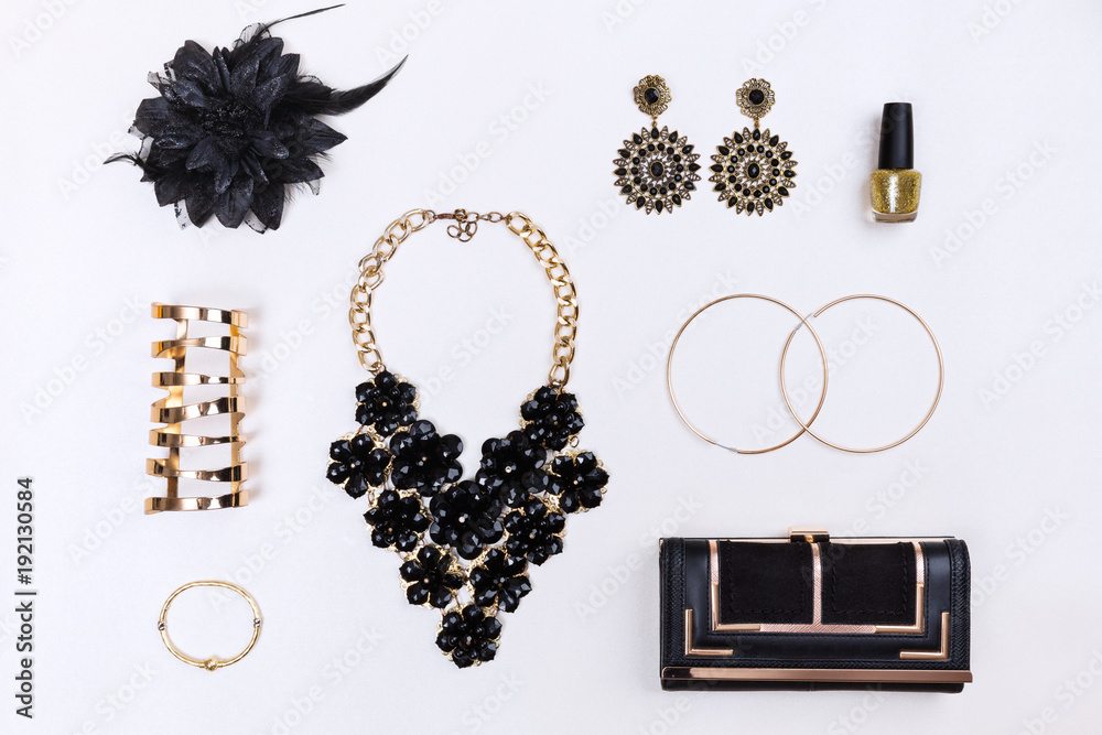 Trendy woman accessories. Black and gold modern jewelry. Top view. Stock  Photo | Adobe Stock