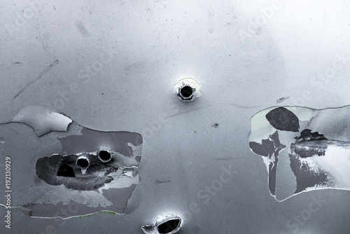 Bullet holes in a car door at a a exercise place