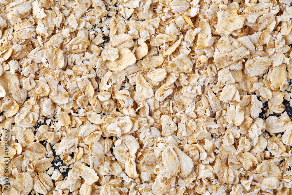 Yellow oats pyramid positioned in the corner on a black stone background Yellow oats pyramid positioned in the corner on a black stone background
