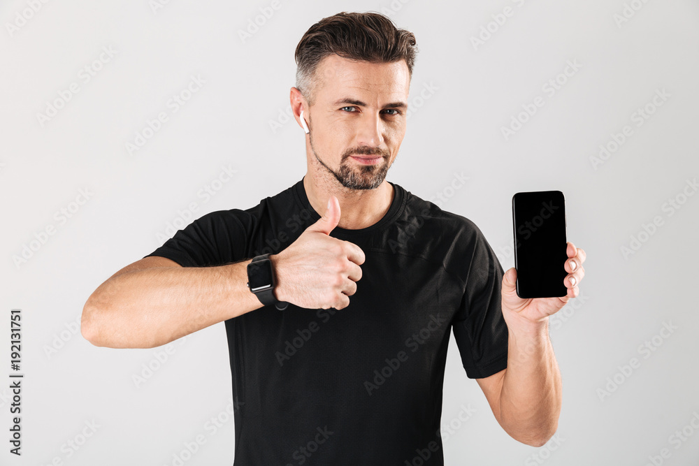 Portrait of a happy mature sportsman in wireless earphones Portrait of a happy mature sportsman in wireless earphones