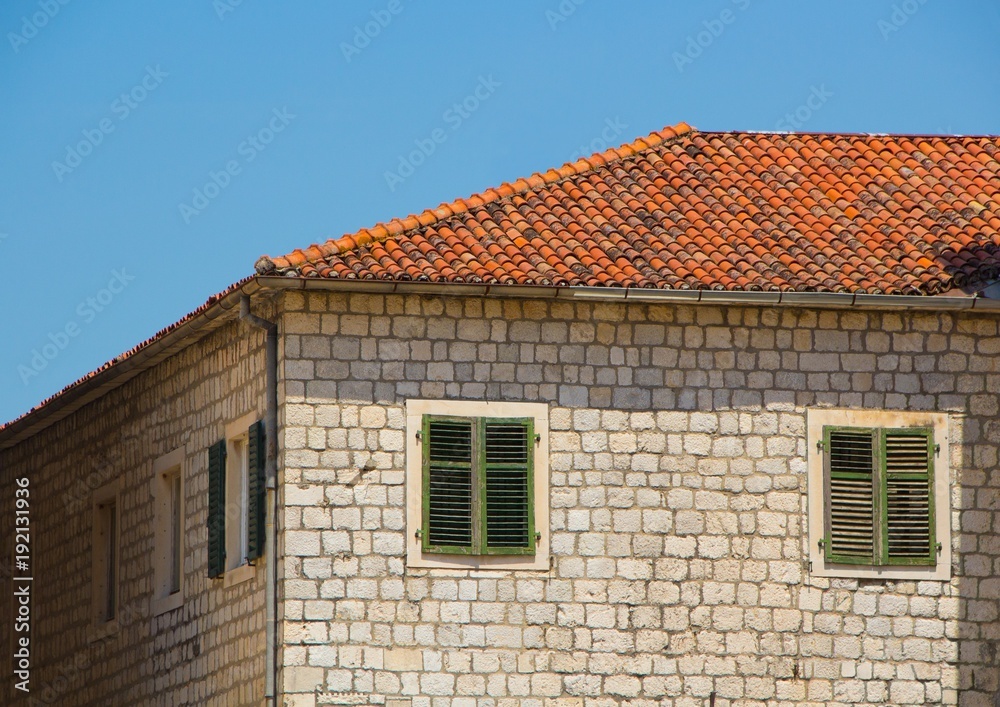 Old brick house with a tiled roof. The old town of Kotor, Montenegro.