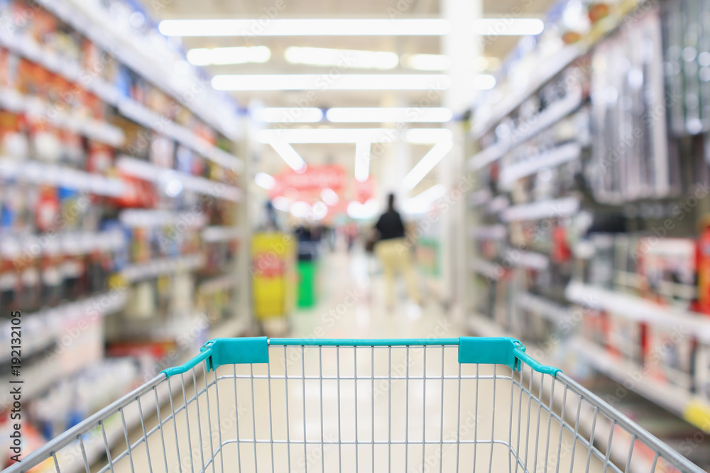 Abstract blur supermarket aisle with hardware and tool background with shopping cart